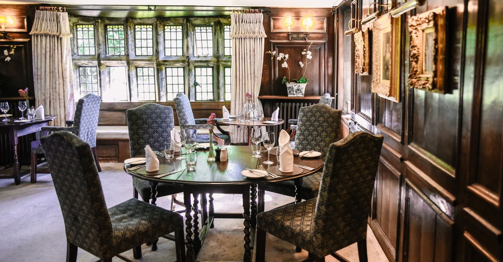 Elegant dining room with historic wood panelling at Holdsworth House.