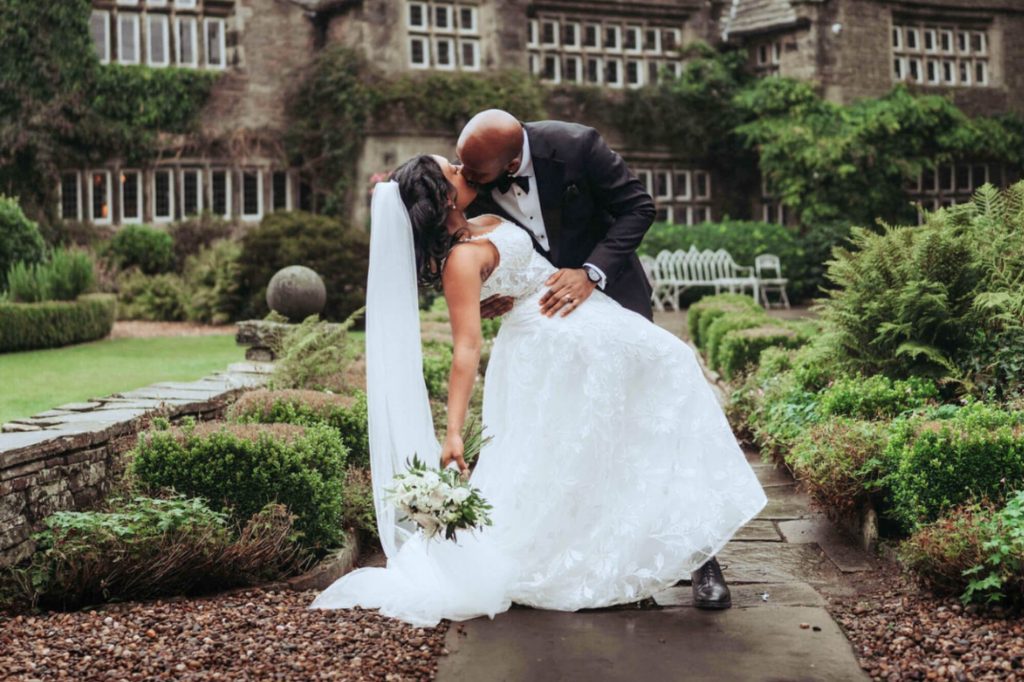couple sharing a kiss in front of holdsworth house