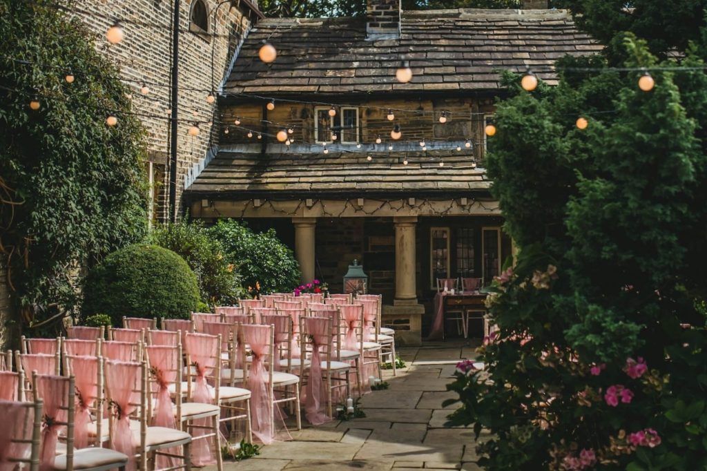 Wedding ceremony taking place in the courtyard at Holdsworth House.