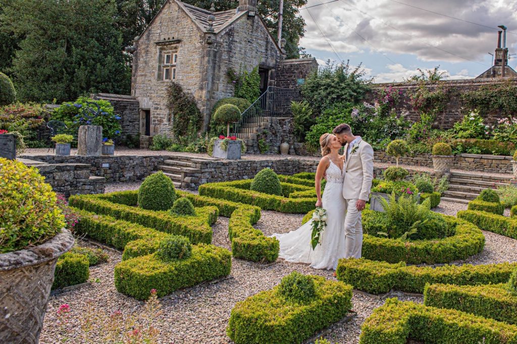 Wedding couple standing together in the gardens at Holdsworth House.
