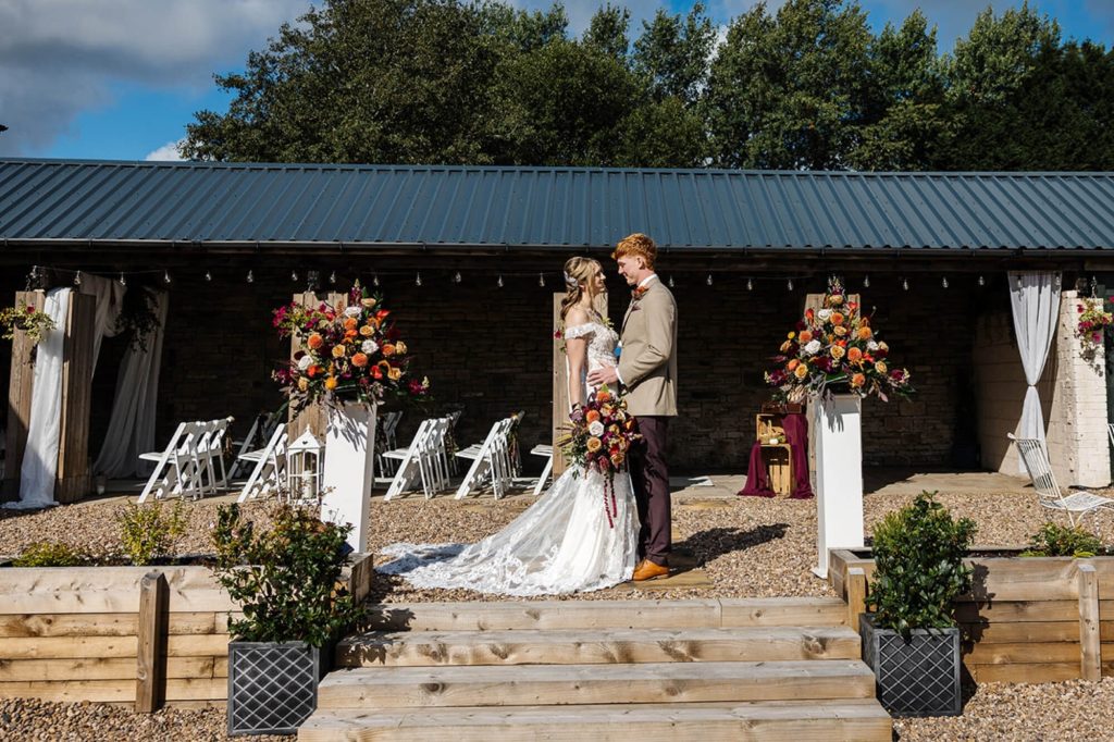 Wedding ceremony set up in the rustic stable space at Holdsworth House.