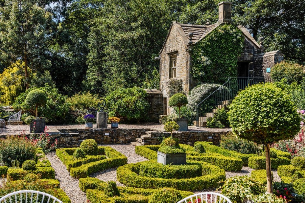 Wedding ceremony held by the stone gazebo at Holdsworth House.