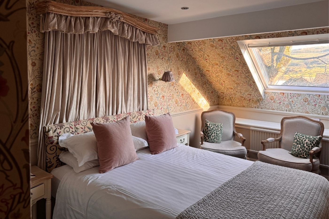 House double bedroom at Holdsworth House with sloping ceiling and seating area