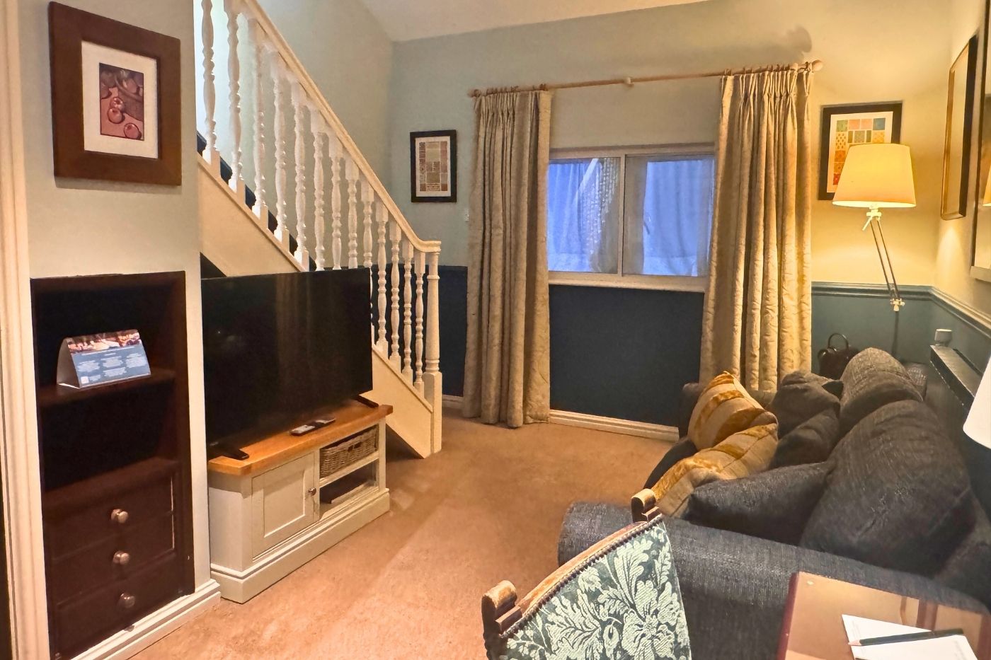 Ground floor lounge in a split-level suite at Holdsworth House with sofa and seating area