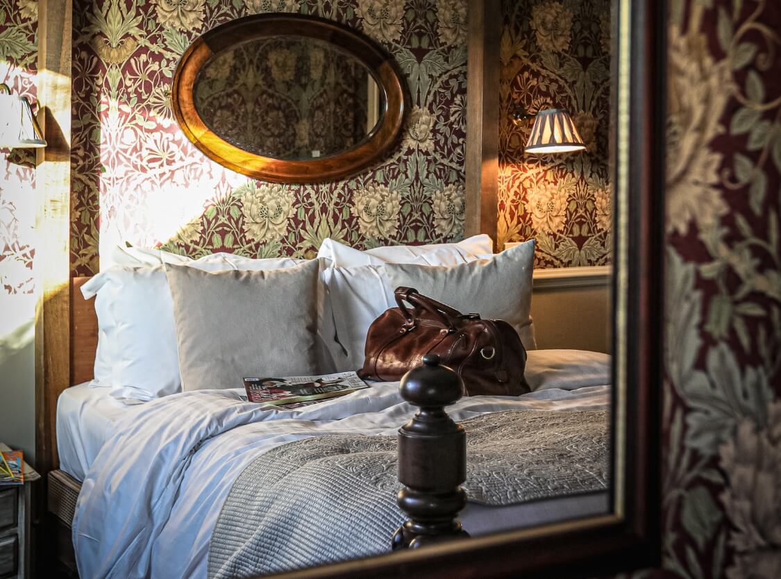 Bedroom in Holdsworth House hotel with a leather bag on the bed