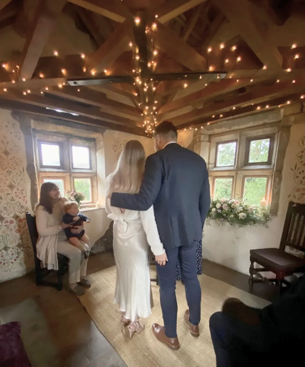 Couple getting married in the stone gazebo at Holdsworth House