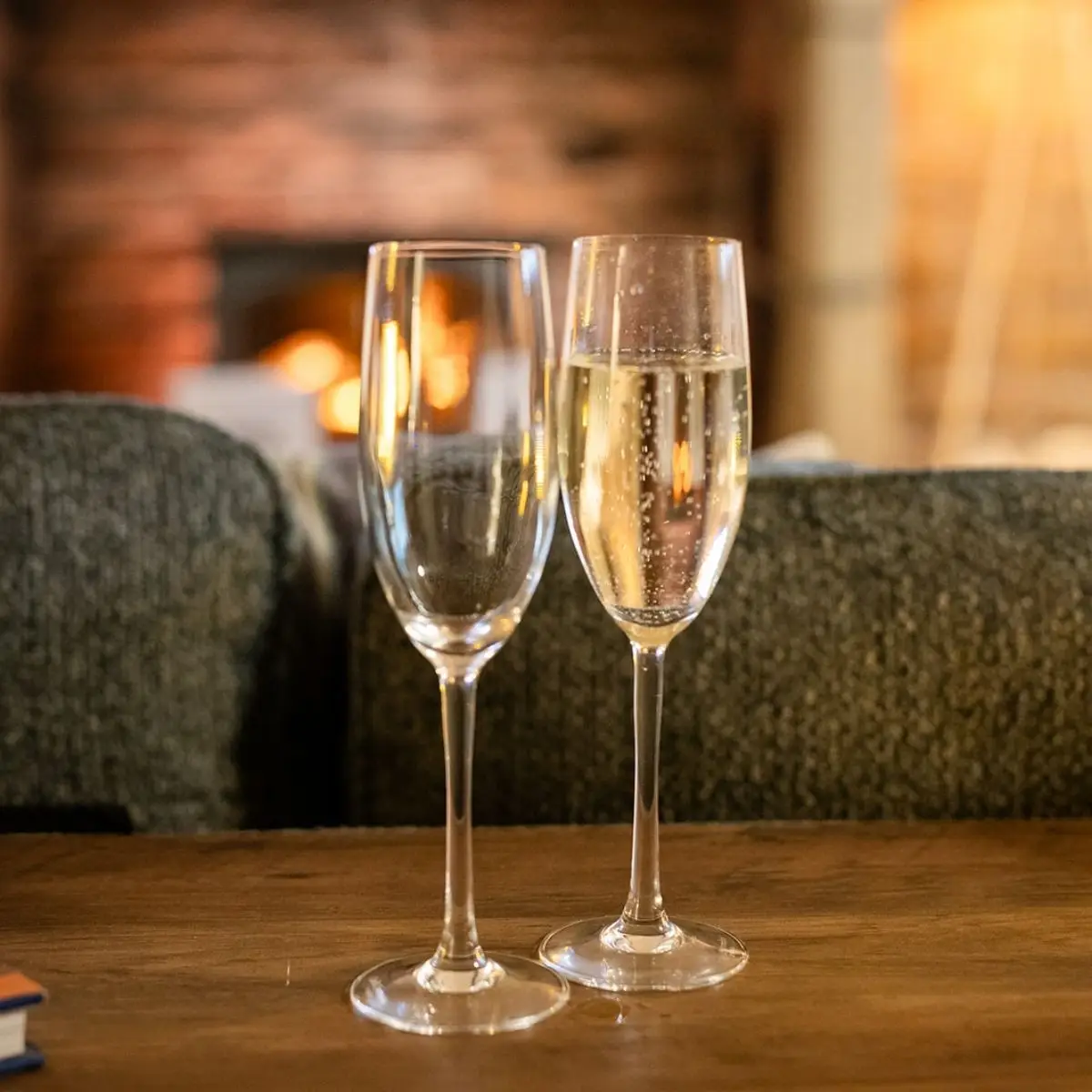 Two glasses of Prosecco by the fire