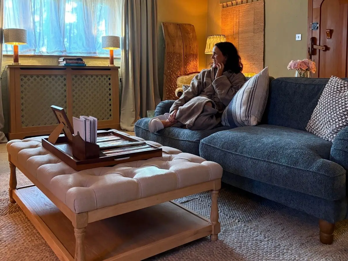 A guest in a robe on the sofa in the lounge