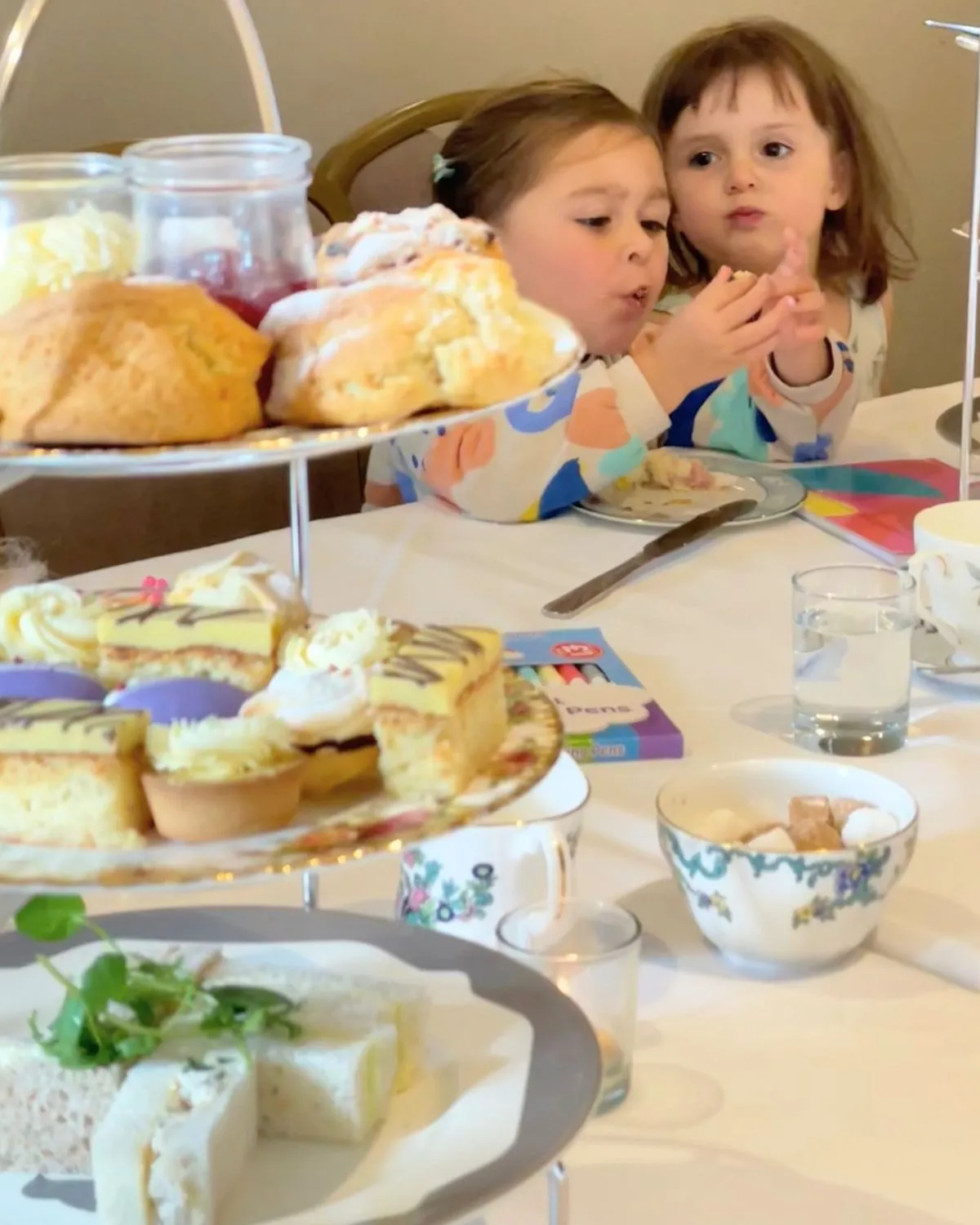 Two children with a three-tier afternoon tea stand at Holdsworth House, Halifax